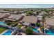 A refreshing in-ground pool, covered patio, and manicured artificial grass highlight this backyard at 10413 E Emelita Ave, Mesa, AZ 85208