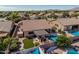 This backyard features a sparkling pool, covered patio, and artificial grass at 10413 E Emelita Ave, Mesa, AZ 85208