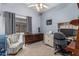 Functional bedroom with ceiling fan and desk offers versatile living space at 10413 E Emelita Ave, Mesa, AZ 85208