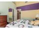 Bedroom featuring storage closet, neutral carpet, and colorful walls at 10413 E Emelita Ave, Mesa, AZ 85208
