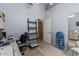 Bedroom featuring versatile space with chair, desk, and adjacent closet area at 10413 E Emelita Ave, Mesa, AZ 85208