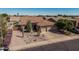 Well-kept home featuring a three-car garage complemented by a xeriscaped front yard at 10413 E Emelita Ave, Mesa, AZ 85208