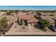 Attractive home boasting a three-car garage, complemented by unique xeriscaping and mature trees at 10413 E Emelita Ave, Mesa, AZ 85208