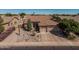 Charming single-story home with a three-car garage and desert landscaping adding curb appeal at 10413 E Emelita Ave, Mesa, AZ 85208