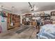Spacious garage with ample storage solutions, including shelving, cabinets, and overhead lighting at 10413 E Emelita Ave, Mesa, AZ 85208