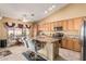Bright eat-in kitchen featuring granite countertops, stainless steel appliances, and a center island at 10413 E Emelita Ave, Mesa, AZ 85208