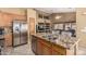Spacious kitchen with stainless steel appliances, granite countertops, and views into the living room at 10413 E Emelita Ave, Mesa, AZ 85208