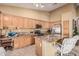 Well-appointed kitchen with granite counters, a center island with seating, and modern appliances at 10413 E Emelita Ave, Mesa, AZ 85208