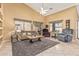 Inviting living room with high ceilings, tile floors, and ample natural light from large windows at 10413 E Emelita Ave, Mesa, AZ 85208