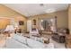 Open concept living area features carpet floors, neutral tones and comfortable seating at 10413 E Emelita Ave, Mesa, AZ 85208
