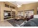Comfortable living room with built-in shelving, a ceiling fan, and views of the landscaped yard at 10413 E Emelita Ave, Mesa, AZ 85208