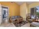 Comfortable living room with tile flooring and ample seating area at 10413 E Emelita Ave, Mesa, AZ 85208