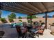 Backyard pool area with a pergola covered outdoor living and dining area at 10413 E Emelita Ave, Mesa, AZ 85208