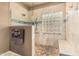 Walk-in shower with grab bar, glass block window, and bench seating offers accessibility at 10413 E Emelita Ave, Mesa, AZ 85208