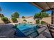 Backyard swimming pool with custom rock features and lush landscaping at 10413 E Emelita Ave, Mesa, AZ 85208