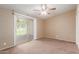 Bright bedroom with carpet flooring and a sliding glass door leading to an outdoor space at 10621 W Oakmont Dr, Sun City, AZ 85351