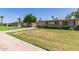 Neighborhood of well-maintained single-story homes with manicured lawns and mature trees at 10621 W Oakmont Dr, Sun City, AZ 85351