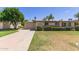 Charming single-story home features a well-manicured lawn, mature trees, and a two-car garage at 10621 W Oakmont Dr, Sun City, AZ 85351