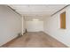Clean, well-lit garage with white walls, concrete flooring, and a window for natural light at 10621 W Oakmont Dr, Sun City, AZ 85351