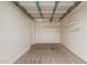 Garage with white walls, concrete flooring, shelving, and an automatic door opener at 10621 W Oakmont Dr, Sun City, AZ 85351