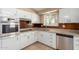 Updated kitchen featuring stainless steel appliances, white cabinets, and stone countertops at 10621 W Oakmont Dr, Sun City, AZ 85351