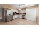 Spacious kitchen featuring stainless steel appliances, white cabinets, and plenty of room for dining at 10621 W Oakmont Dr, Sun City, AZ 85351