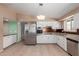 An open kitchen with stainless steel appliances, white cabinets and adjacent dining area at 10621 W Oakmont Dr, Sun City, AZ 85351