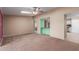 Open living room layout with neutral carpet, and various entryways to other rooms at 10621 W Oakmont Dr, Sun City, AZ 85351