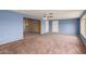 Spacious living room with neutral carpet, ceiling fan, and view of the golf course at 10621 W Oakmont Dr, Sun City, AZ 85351