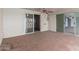 Covered patio with tile flooring, ceiling fan and sliding glass doors to the interior of the home at 10621 W Oakmont Dr, Sun City, AZ 85351