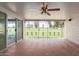 Covered patio with tile flooring, ceiling fan, and iron fencing with golf course views beyond at 10621 W Oakmont Dr, Sun City, AZ 85351
