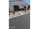 Manicured front yard with seating, desert plants, and easy-care rock landscaping at 11596 W Sierra Dawn Blvd # 247, Surprise, AZ 85378