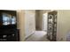 Hallway view with neutral carpet, closet, and decorative display cabinet at 11596 W Sierra Dawn Blvd # 247, Surprise, AZ 85378
