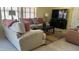 Well-lit living room featuring a large sectional sofa, stylish decor, and a contemporary TV at 11596 W Sierra Dawn Blvd # 247, Surprise, AZ 85378