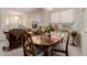 Bright dining area with a polished wood table set for four, complemented by natural light at 11691 W Cactus Wren Ct, Surprise, AZ 85378