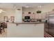 Bright kitchen with stainless steel appliances, a breakfast bar, and ample counter space at 11691 W Cactus Wren Ct, Surprise, AZ 85378