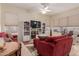 Cozy living room with plush sofas, built-in shelving, and large windows at 11691 W Cactus Wren Ct, Surprise, AZ 85378