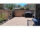 A brick patio with garden fixtures and a barbecue provides an ideal space for outdoor entertaining and relaxation at 1465 S Longspur S Ln, Gilbert, AZ 85296