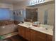 Bathroom showcasing double sinks, a separate tub, a shower, and blue-painted accent wall at 1465 S Longspur S Ln, Gilbert, AZ 85296