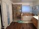 Bathroom with a luxurious shower, a relaxing tub, and stylish wood-look flooring at 1465 S Longspur S Ln, Gilbert, AZ 85296
