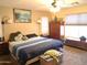 Comfortable bedroom featuring a queen bed, ceiling fan, and natural light from the window at 1465 S Longspur S Ln, Gilbert, AZ 85296