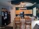 Well-lit kitchen featuring wood cabinetry, black appliances, and a breakfast bar with seating at 1465 S Longspur S Ln, Gilbert, AZ 85296