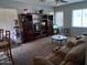 Cozy living room is furnished with a plush recliner and an entertainment center at 1465 S Longspur S Ln, Gilbert, AZ 85296