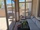 Enclosed patio featuring a comfortable seating arrangement with natural light and garden views at 1465 S Longspur S Ln, Gilbert, AZ 85296