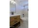 Bathroom featuring a wood vanity, quartz countertop and stylish fixtures at 16447 W Cottonwood St, Surprise, AZ 85388