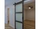 Stylish sliding barn door that adds unique charm to the bedroom at 16447 W Cottonwood St, Surprise, AZ 85388