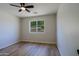Inviting bedroom with a window offering a pleasant view and a ceiling fan at 16447 W Cottonwood St, Surprise, AZ 85388
