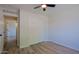 Bedroom featuring wood-look tile flooring, a closet and a ceiling fan at 16447 W Cottonwood St, Surprise, AZ 85388