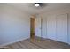 Bedroom features wood-look flooring, closet and a ceiling fan at 16447 W Cottonwood St, Surprise, AZ 85388