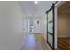 Inviting entryway featuring wood-look tile floors, a glass sliding barn door and ample natural light at 16447 W Cottonwood St, Surprise, AZ 85388